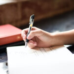 woman writing in a notebook