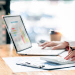 Businesswoman or accountant working Financial investment on calculator, calculate, analyze business and marketing growth on financial document data graph, Accounting, Economic, commercial concept.